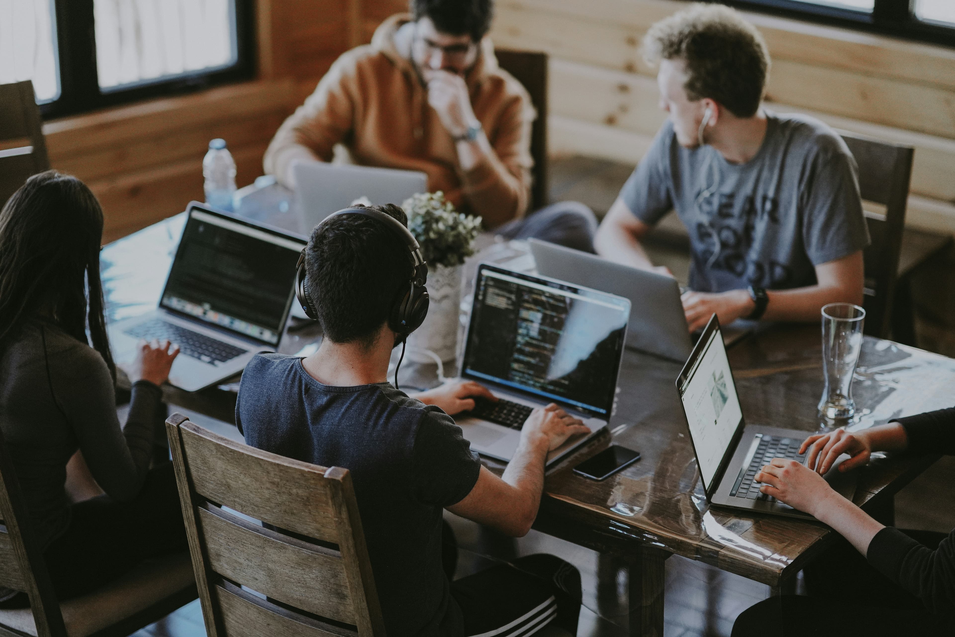 Cross-functional team collaborating across web, mobile, AI, and cloud capabilities in a modern workspace